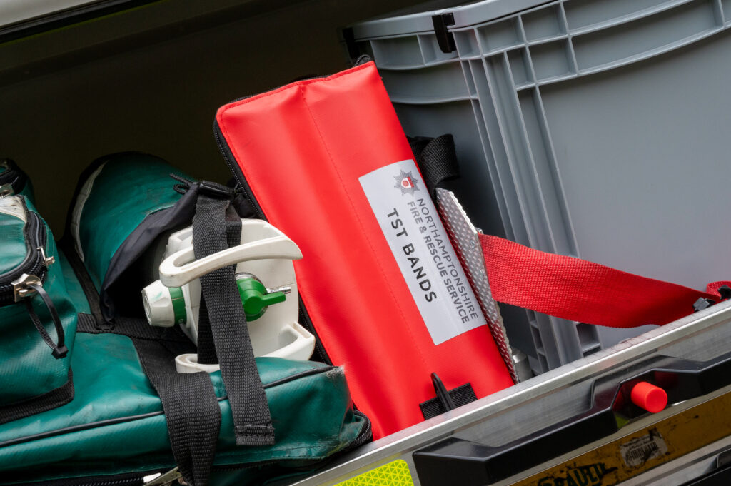 Red ten second triage bands are shown stowed away in a fire engine.