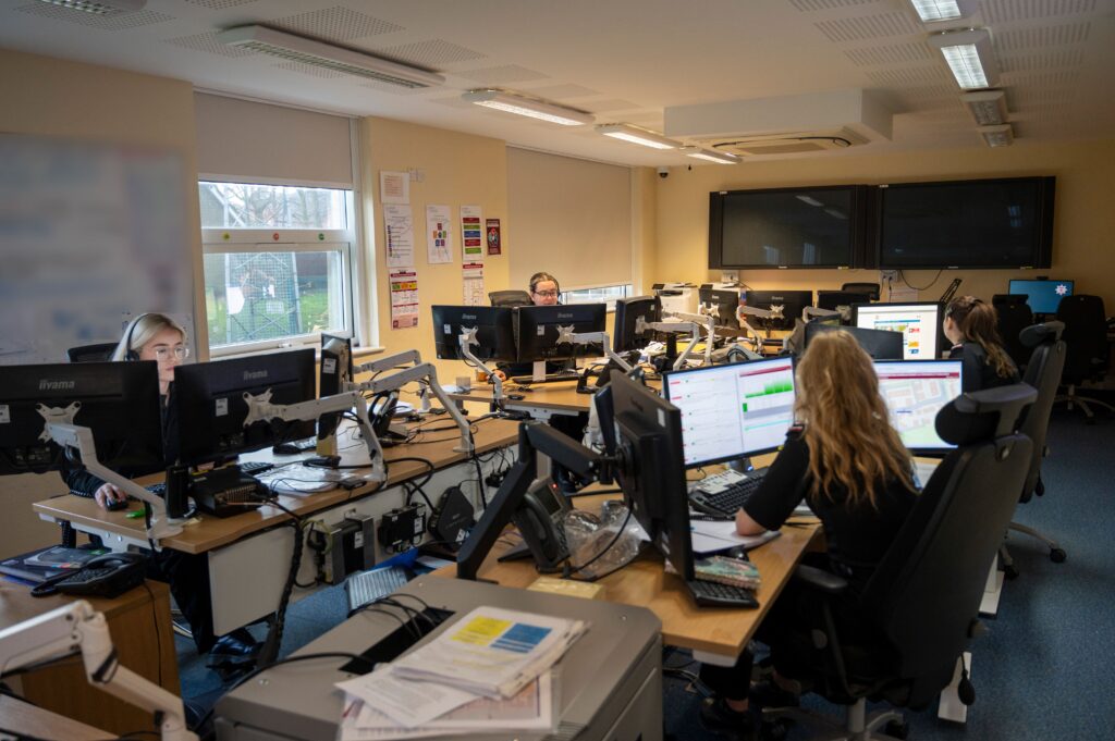 An array of staff on computers, wearing headsets in the Control Room in Daventry