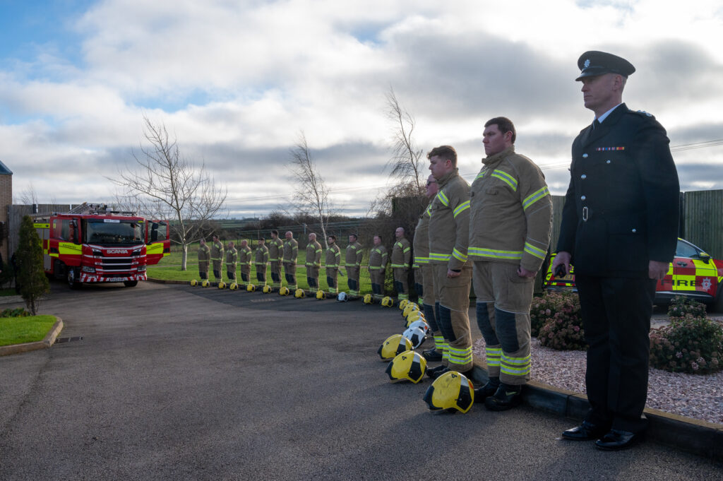 Firefighters in fire kit as part of a guard of honour